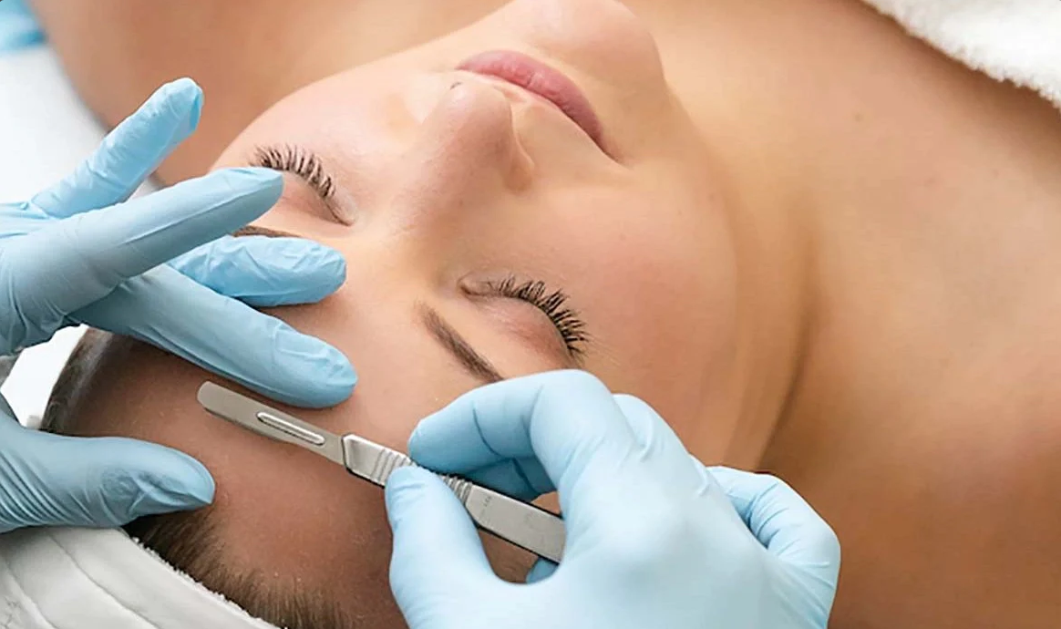 Dermaplane facial service being performed on a woman's cheek at Skin in The Ranch, Rancho Santa Fe CA.