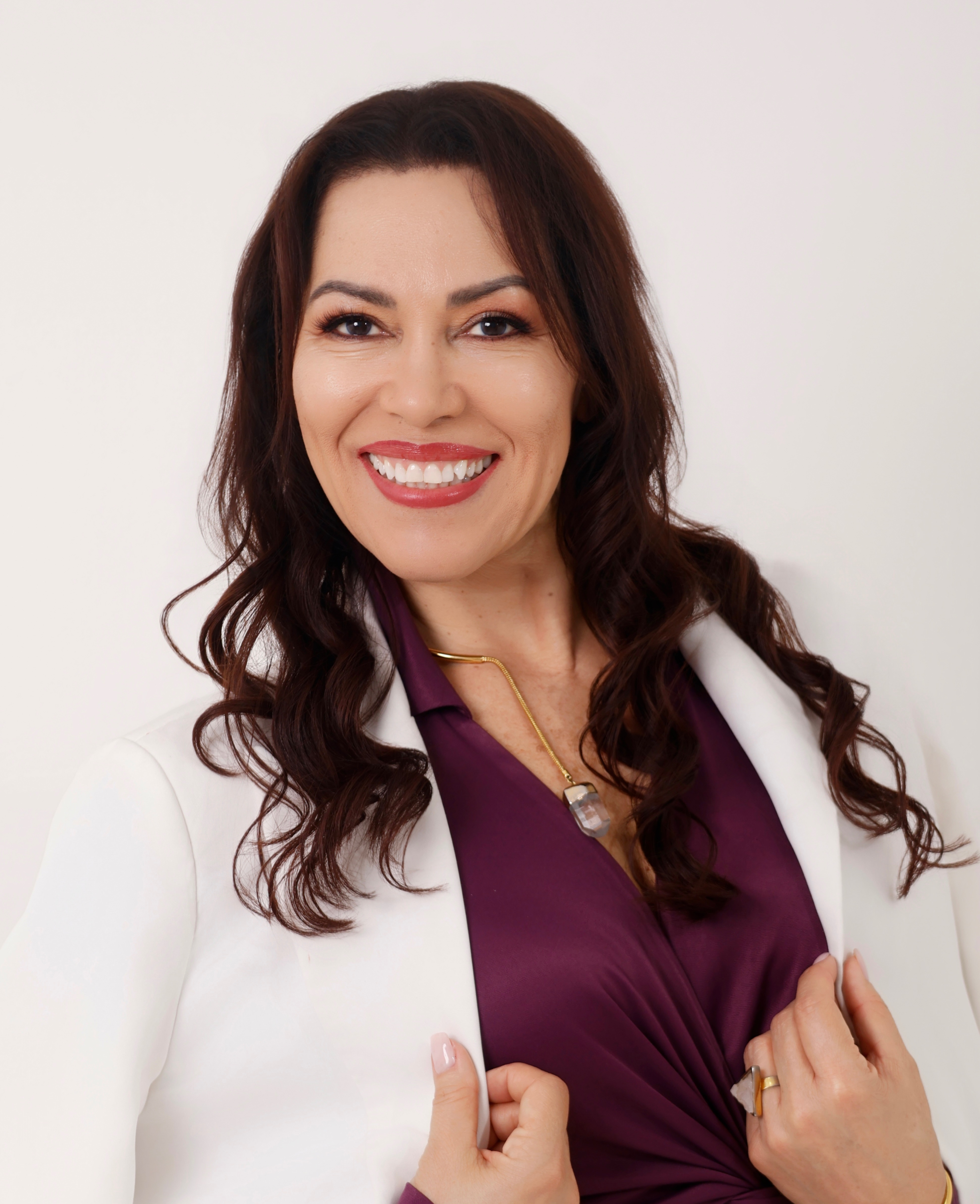 A photograph of Kristi in front of her Hydrafacial skincare machine